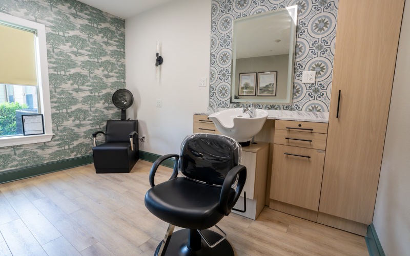 a salon with a hair sink and mirror
